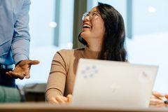 smiling woman conversing with a man