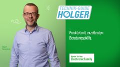 Lächelnder Mitarbeiter mit der Bezeichnung "Technik-Guide Holger"