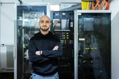 Ein IT Mitarbeiter vor einer Schaltzentrale.