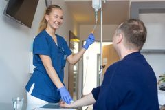 Eine Frau macht eine Ausbildung zur Pflegefachkraft bei der Kaiserswerther Diakonie und unterstützt gerade einen Patienten.