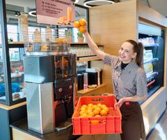 Auszubildende füllt Orangen nach